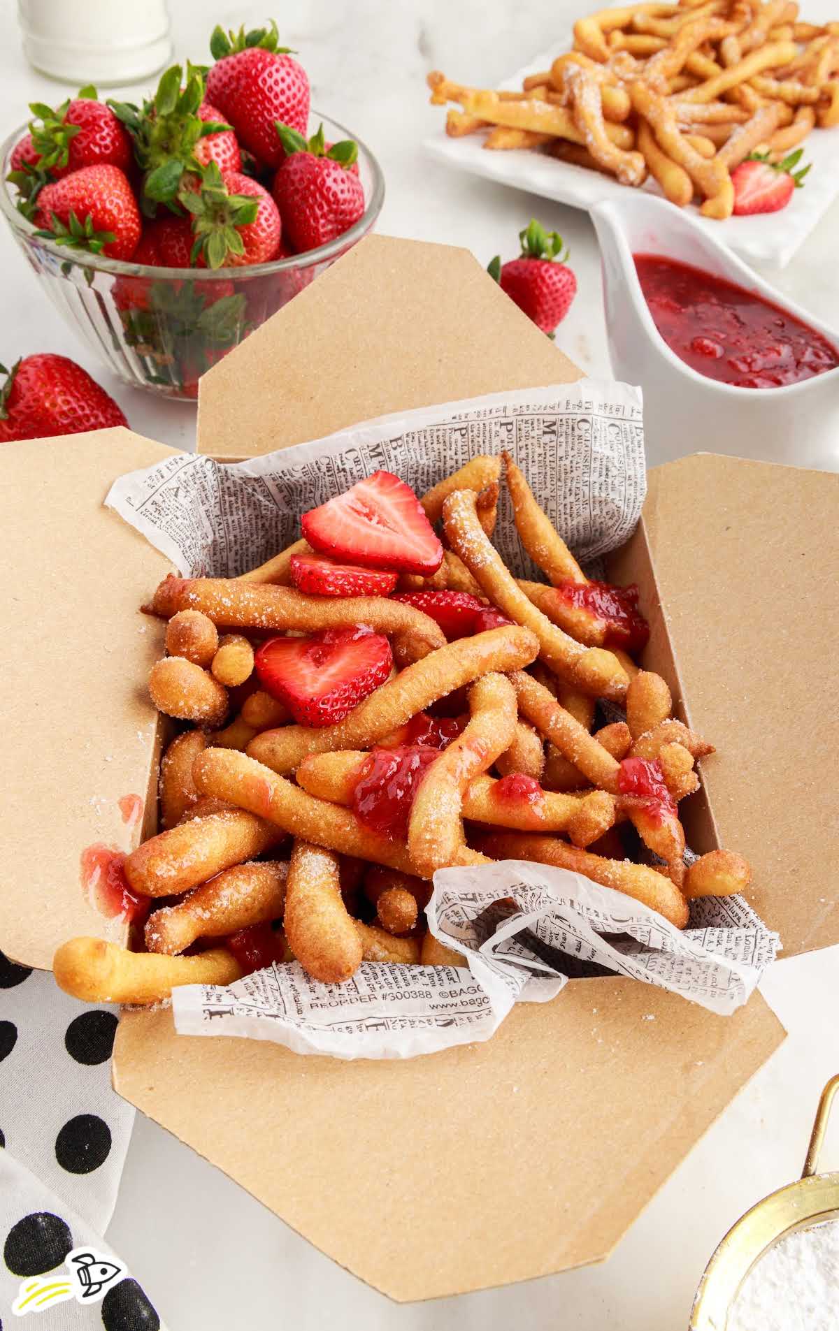 close up shot of Funnel Cake Fries in a brown box