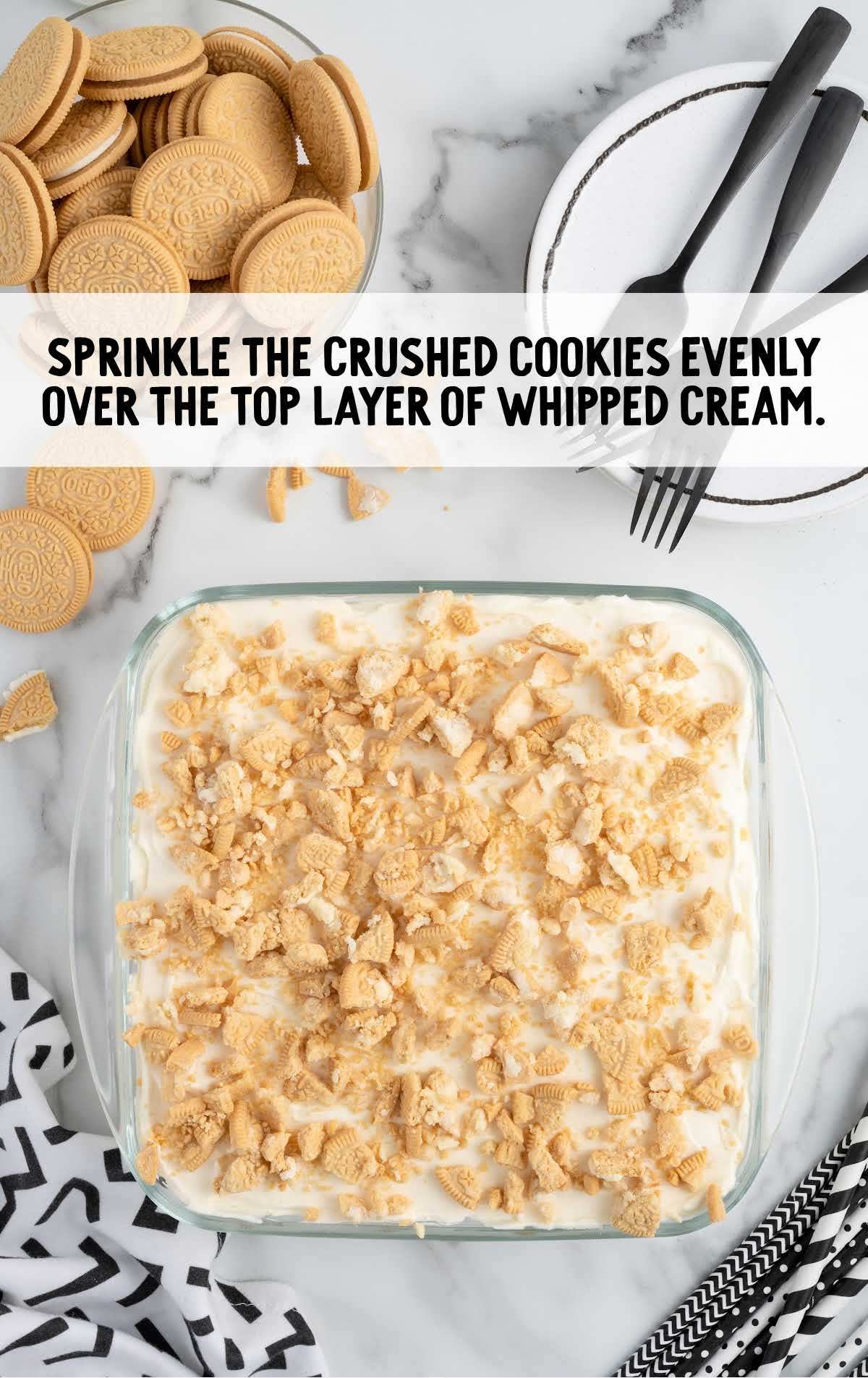 crushed cookies sprinkled over the layer of whipped cream