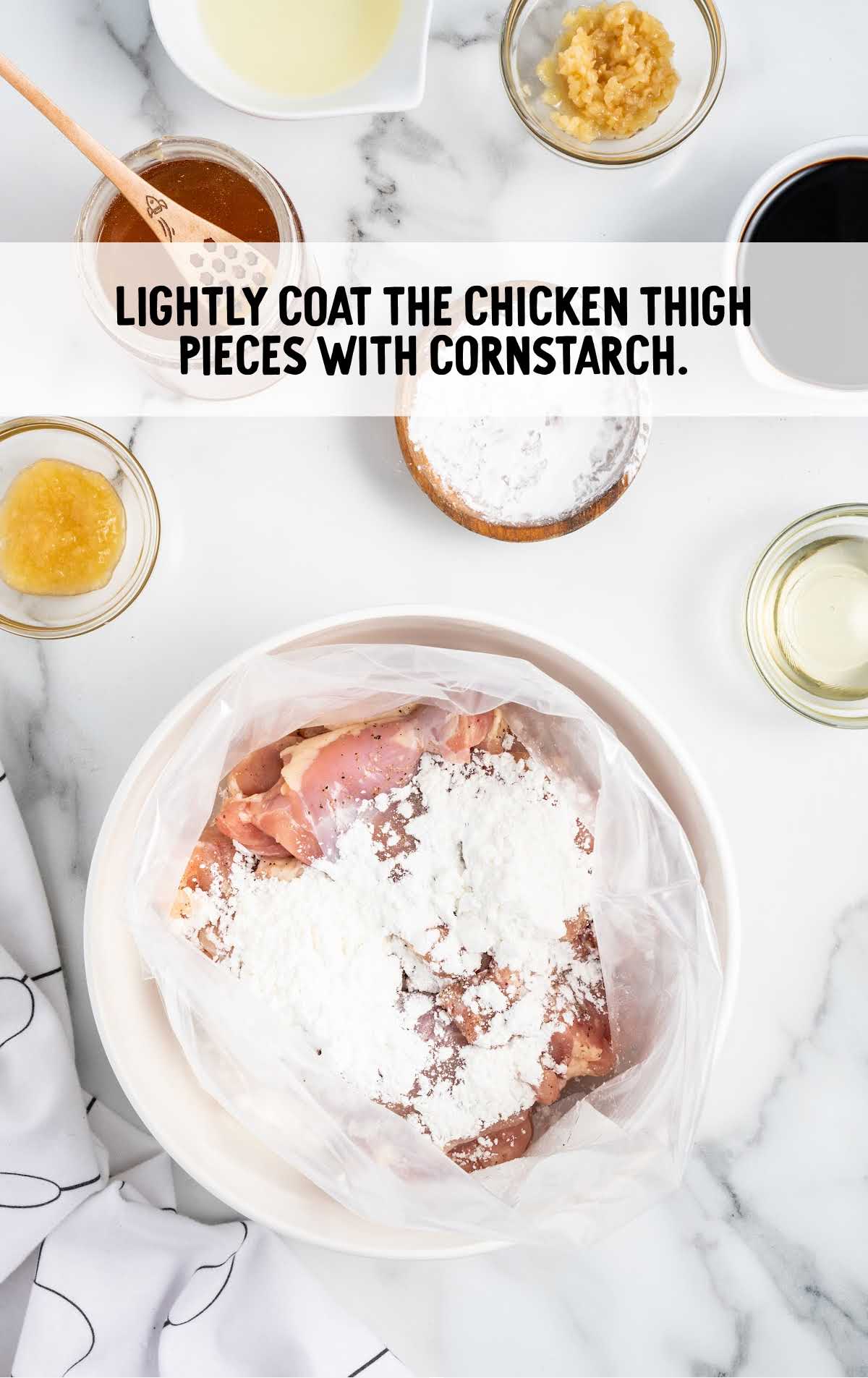 chicken thighs coated with cornstarch in a bag