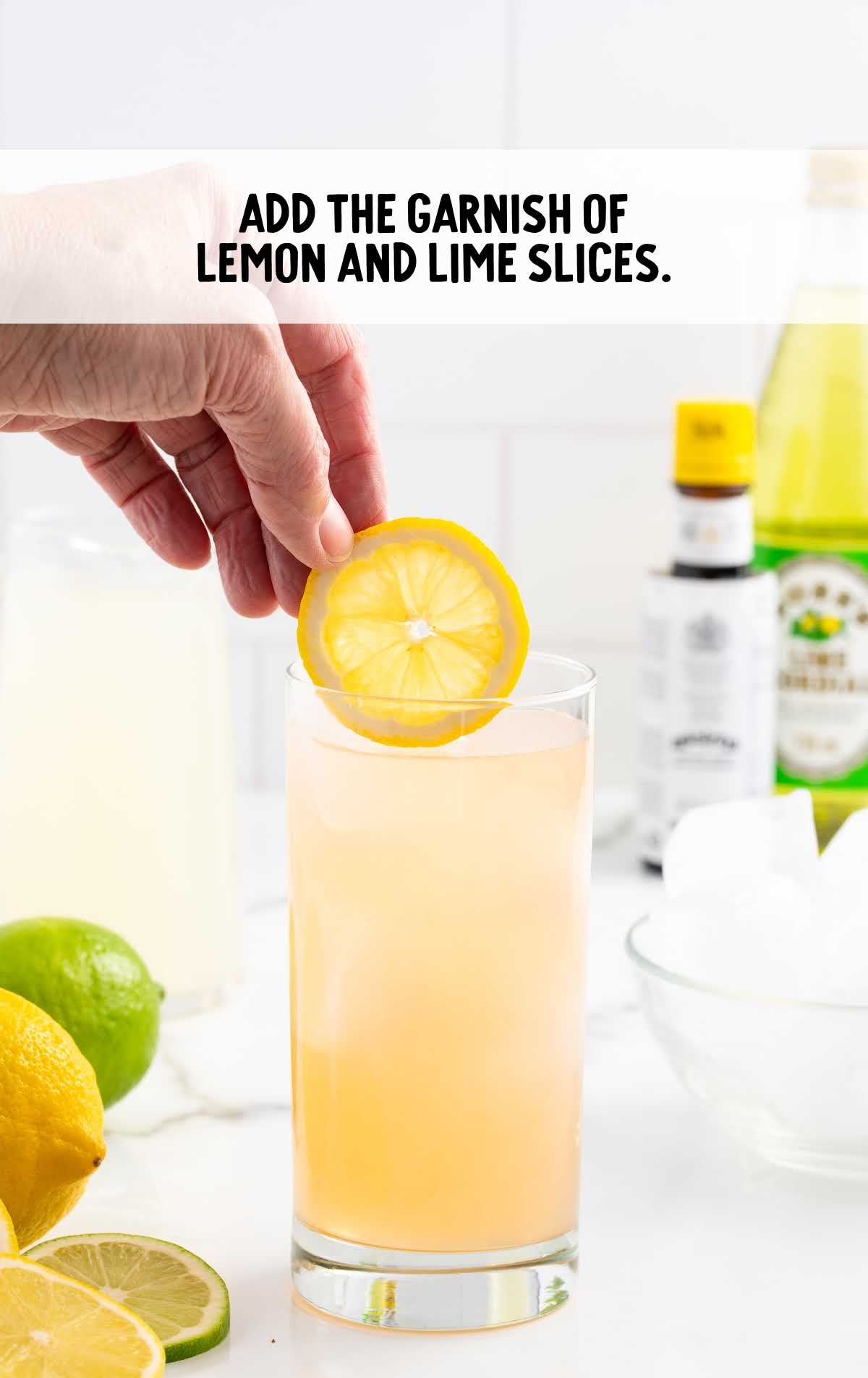 slices of lemon added to a glass of Lemon Lime Bitters