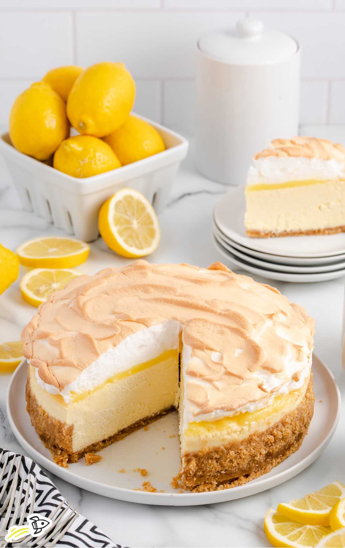 a close-up shot of Lemon Meringue Cheesecake with a slice taken out