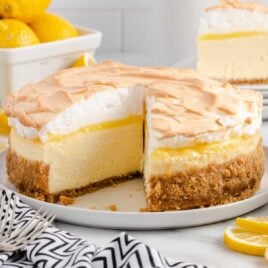 a close-up shot of Lemon Meringue Cheesecake with a slice taken out