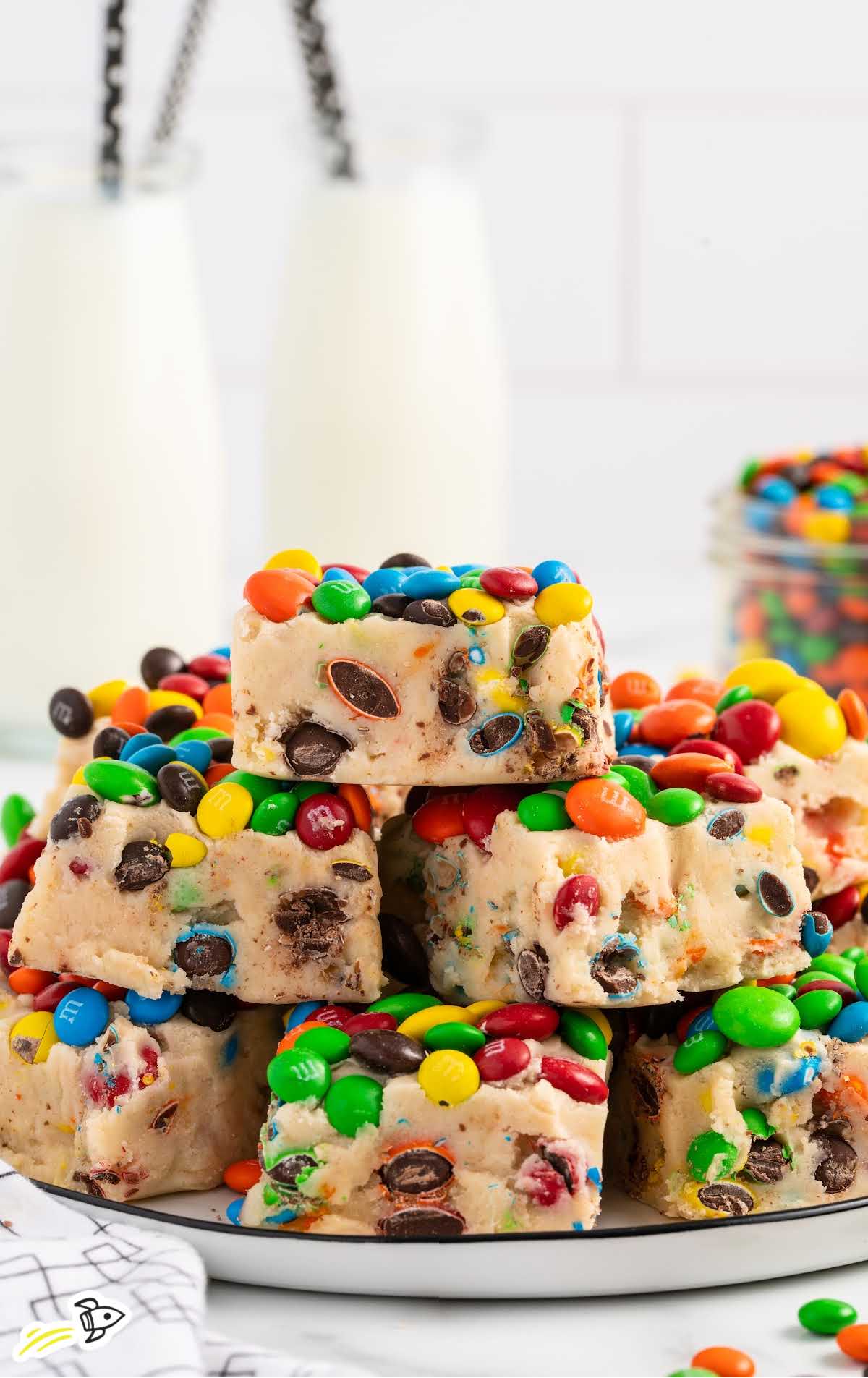 Monster Cookie Dough Fudge stacked on top of each other on a plate