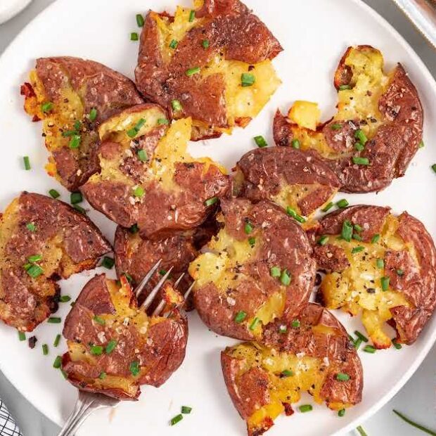 overhead shot of pieces of Smashed Red Potatoes on a plate