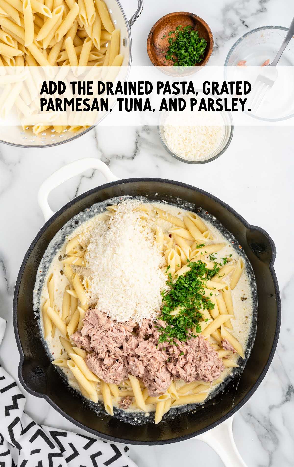 add the rained cooked pasta, grated parmesan cheese, drained canned tuna, and chopped fresh parsley to the pot
