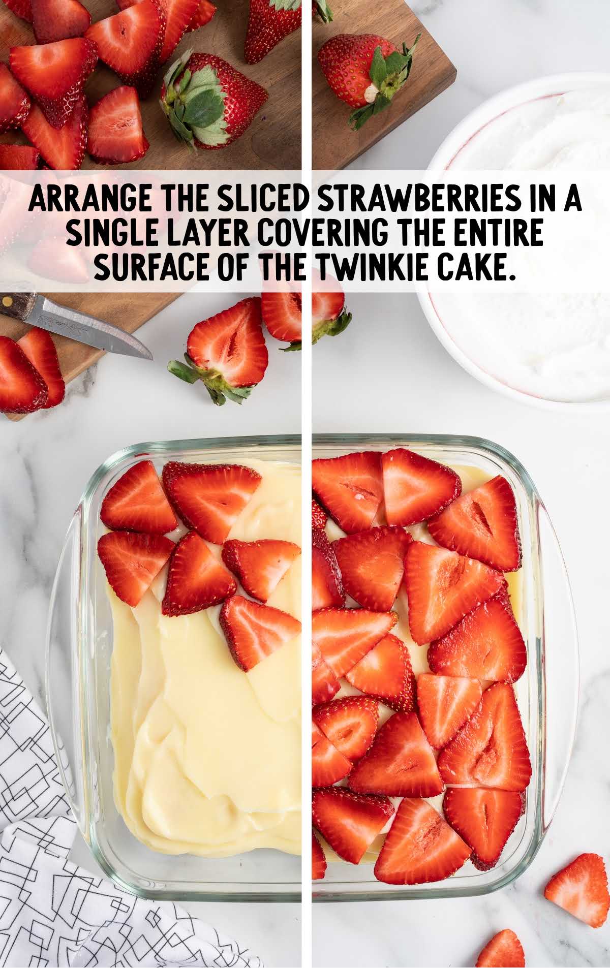 sliced strawberries spread on top of the cake