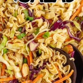 Overhead view of ramen noodle salad in bowl with wooden spoons and text overlay that reads 'One of a Kind Ramen Noodle Salad'