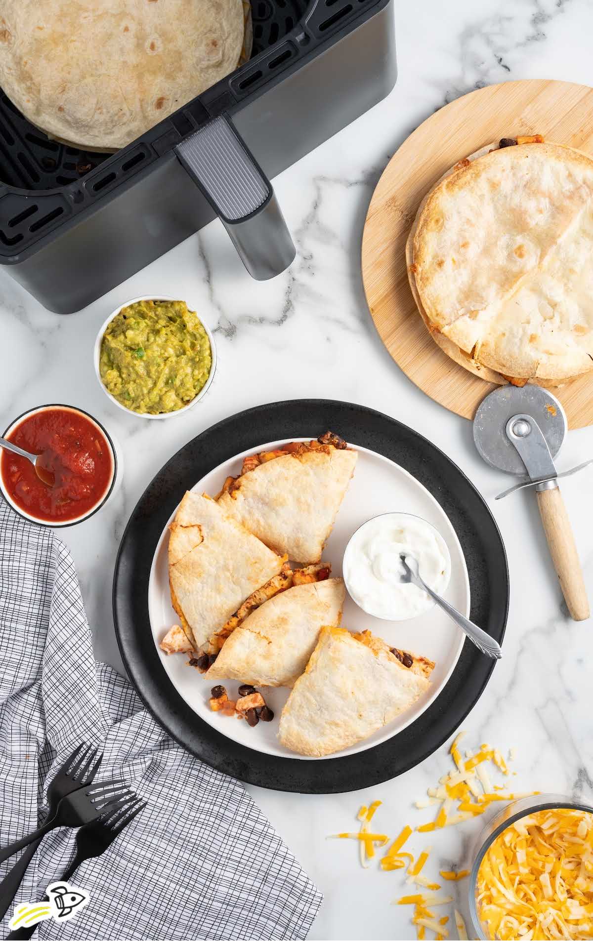 overhead shot of Air Fryer Quesadilla piled on top of each other on a plate