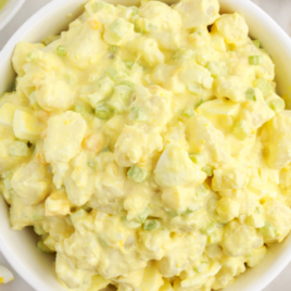 A white bowl is full of Amish Potato Salad