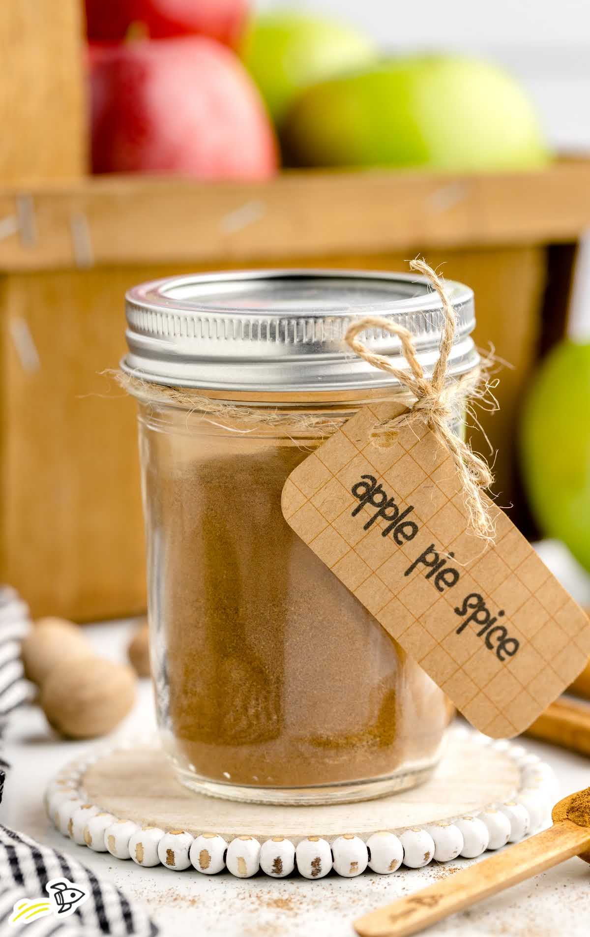 close up shot of a jar of Apple Pie Spice with a spoon with a label