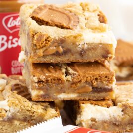 a close up shot of Biscoff Blondies stacked on top of each other