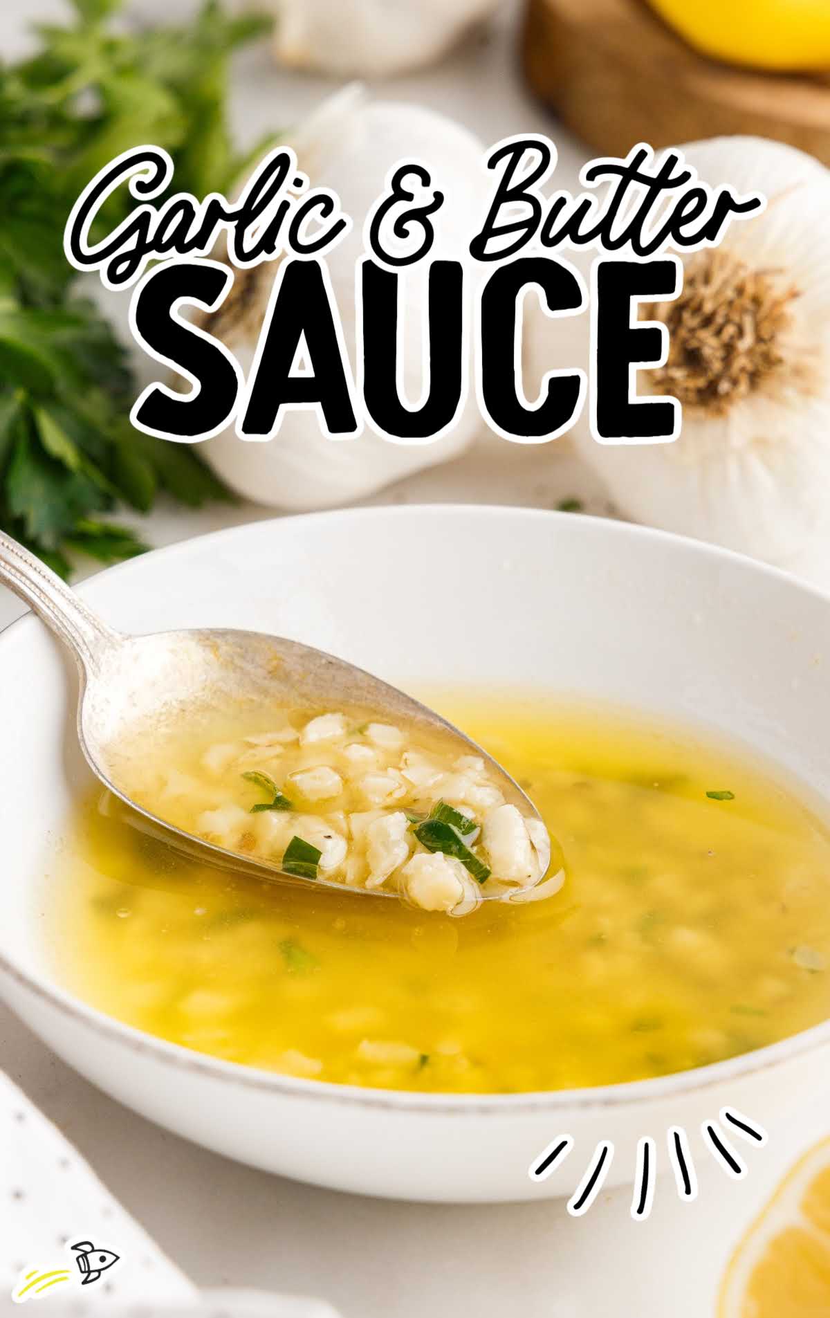 close up shot of Garlic & Butter Sauce in a bowl with a spoon