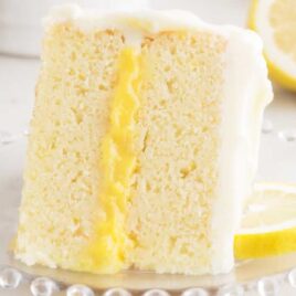 a close up shot of a slice of Lemon Curd Cake on a plate