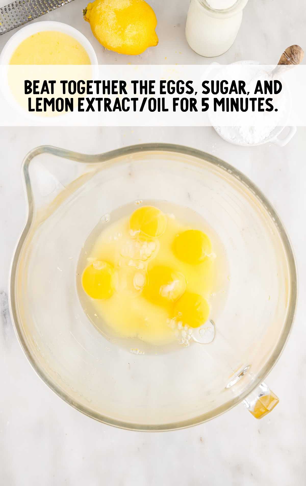 eggs, sugar, and lemon extract/oil combined in a bowl