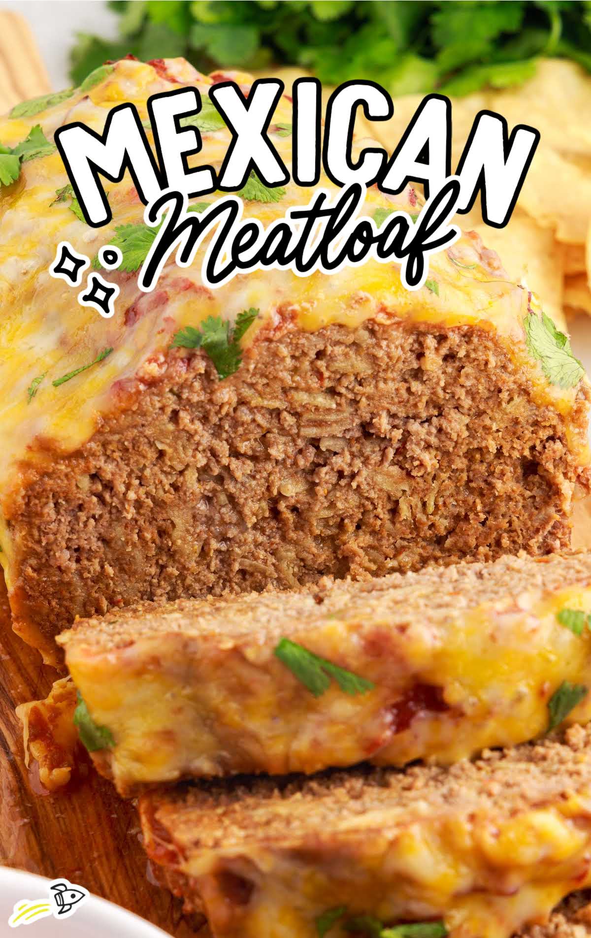 close up shot of a loaf of Mexican Meatloaf with slices topped with cilantro