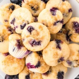 close up shot of a bunch of Mini Blueberry Muffins on a plate