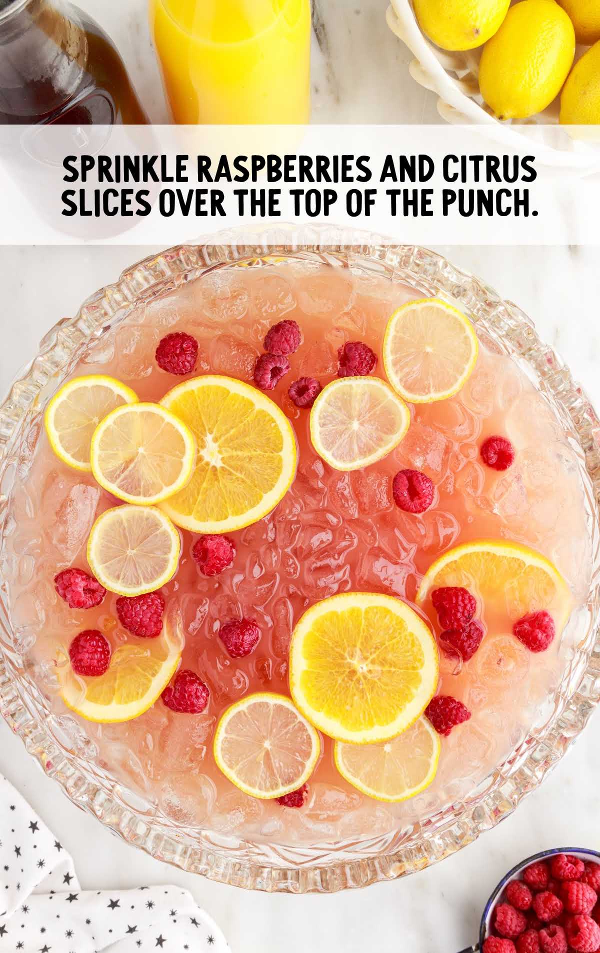 raspberries and slices of lemon added to the punch bowl