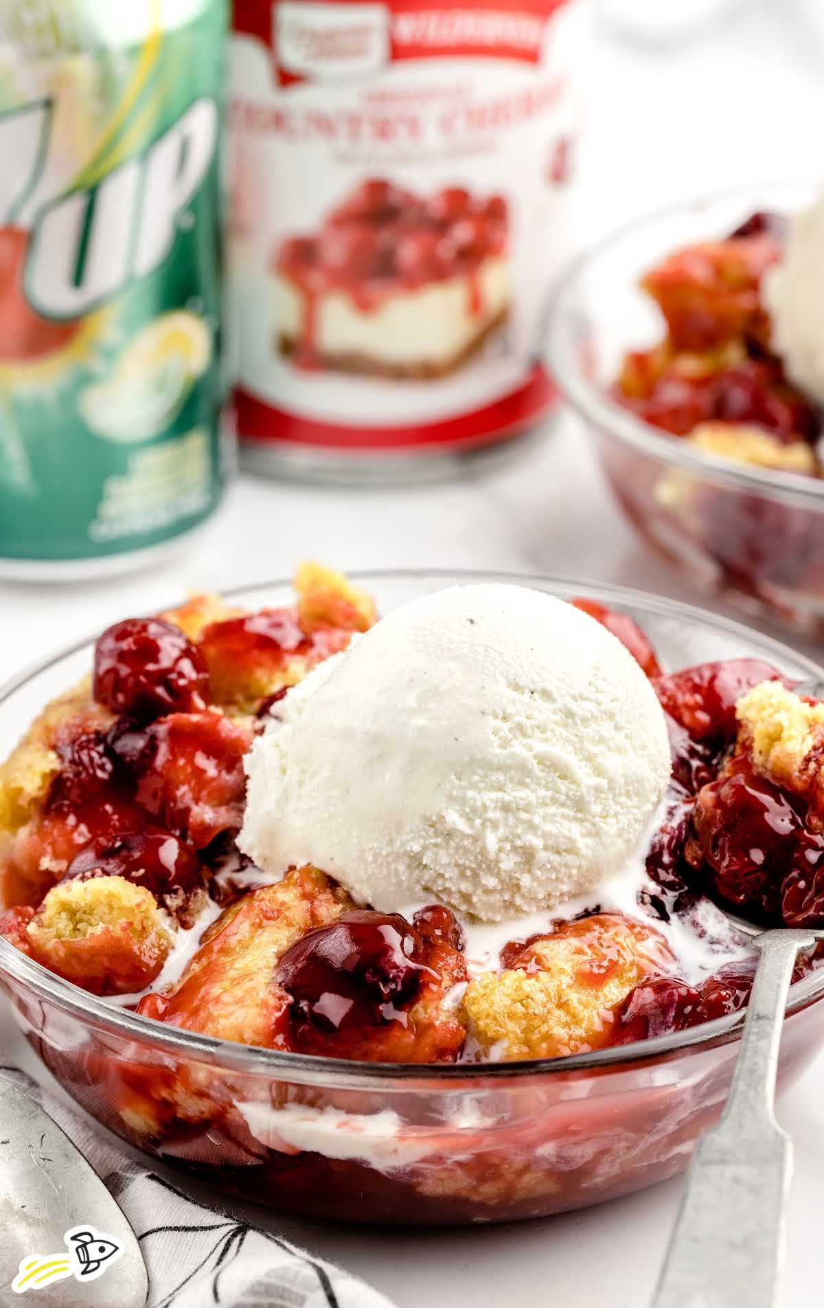 a close up shot of 7UP Cherry Cobbler in a bowl topped with ice cream