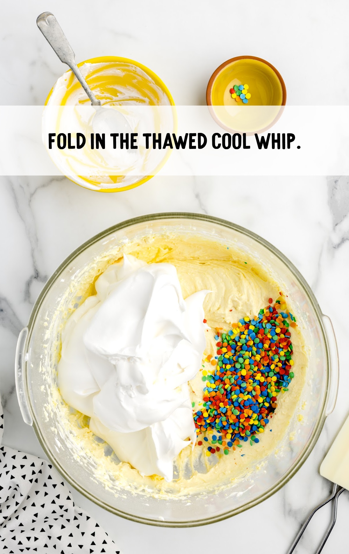 thawed Cool Whip folded into the ingredients in the bowl