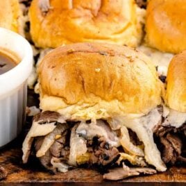 close up shot of French Dip Sliders with a bowl of sauce