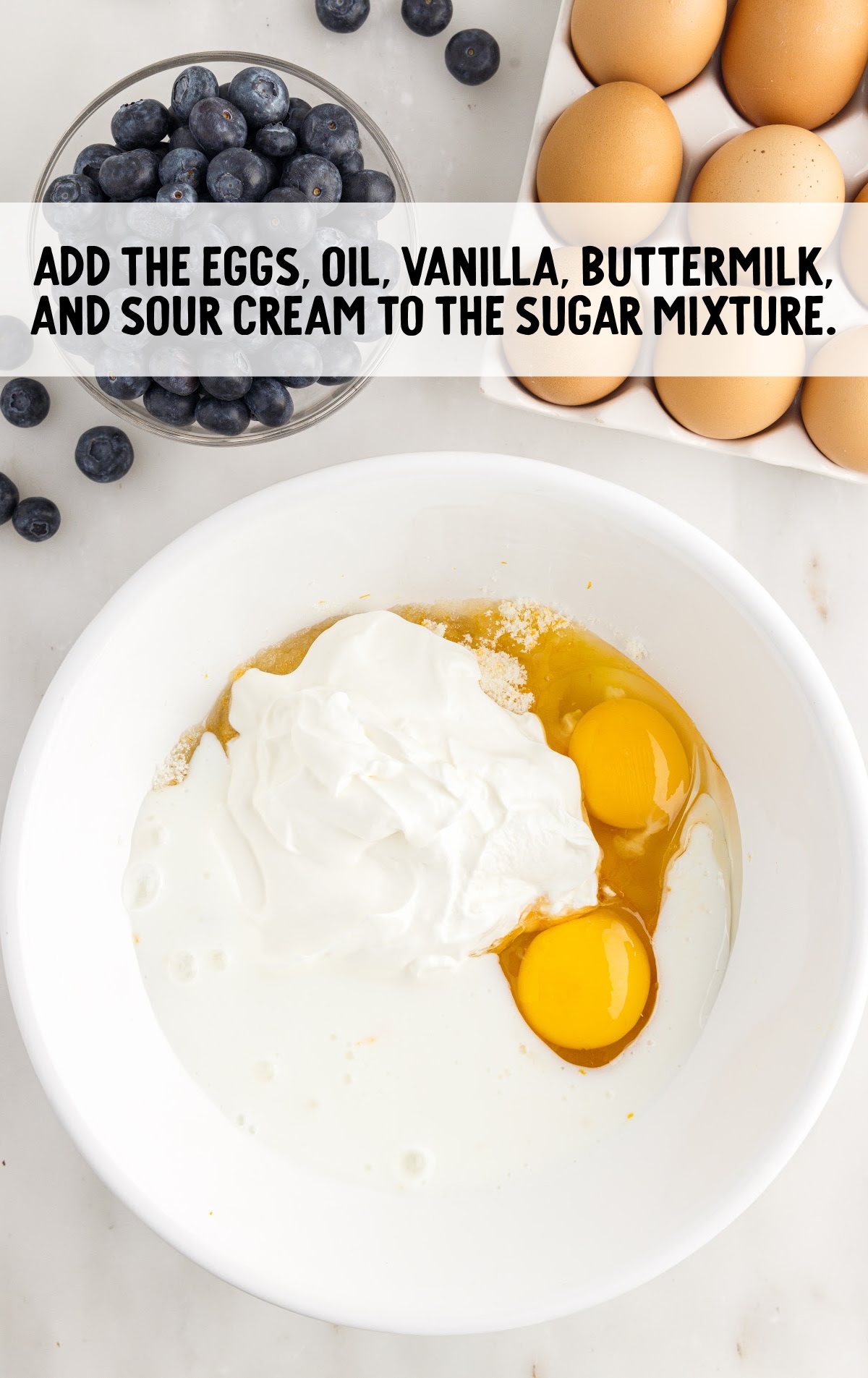 egg, oil, vanilla, buttermilk, and sour cream added to the sugar mixture