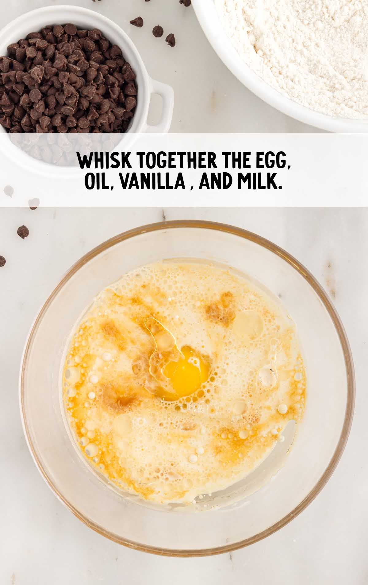 egg, oil, vanilla, and milk whisked in a bowl