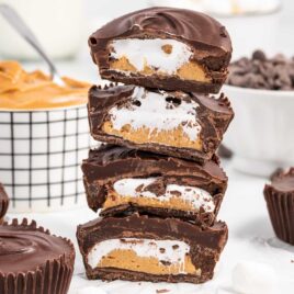 close up shot of Peanut Butter Marshmallow Cups stacked on top of each other with a bite taken out of them
