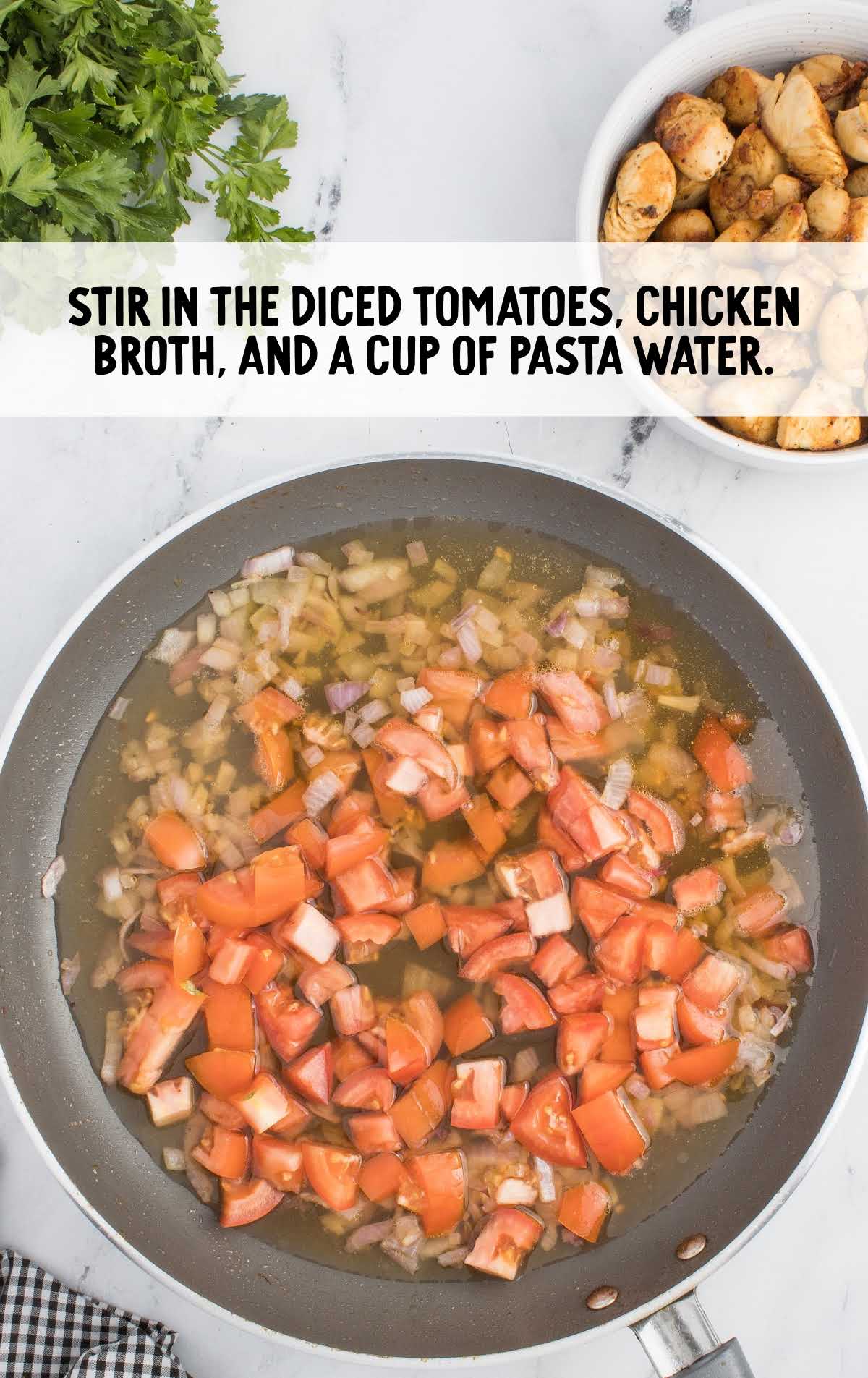 diced tomatoes, chicken broth, and pasta water added to the skillet