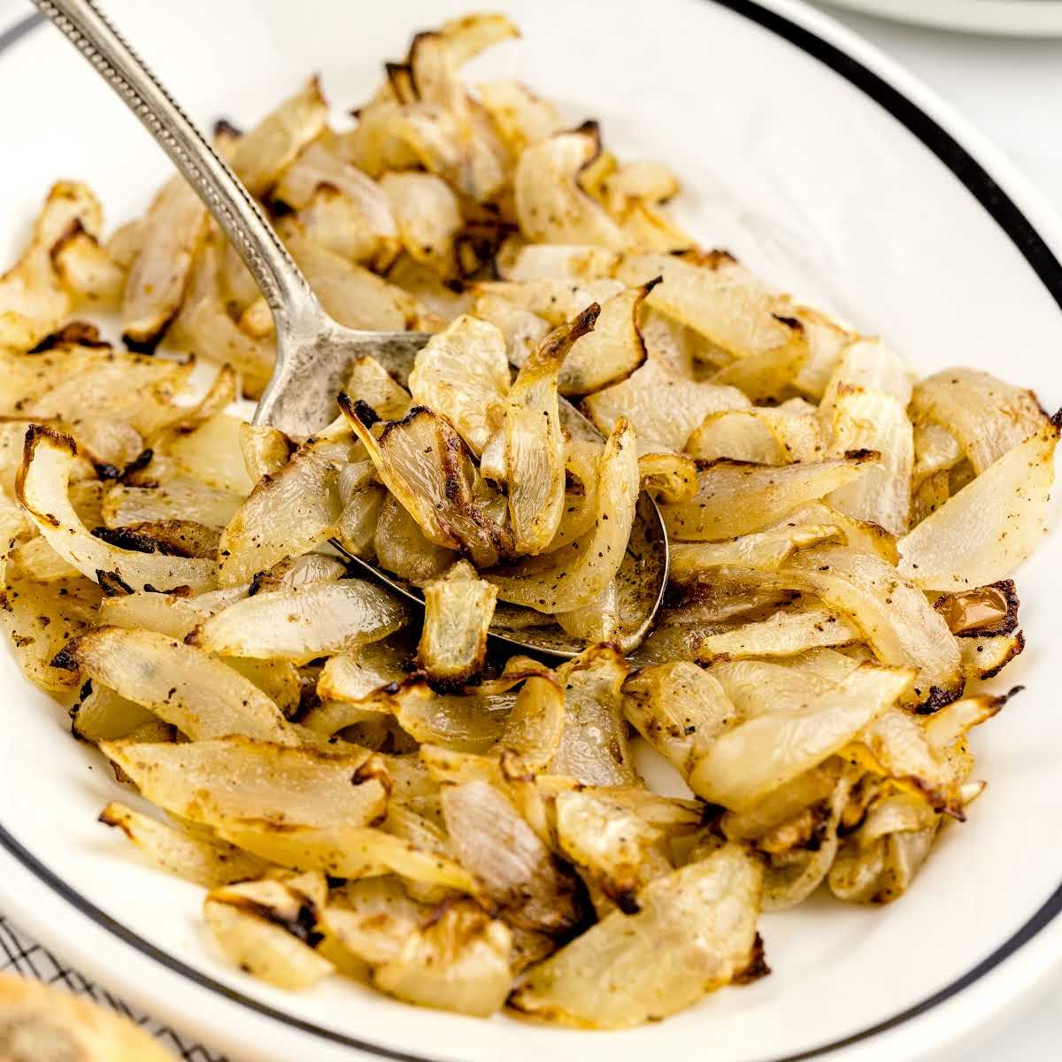 a close up shot of Air Fryer Onions on a plate