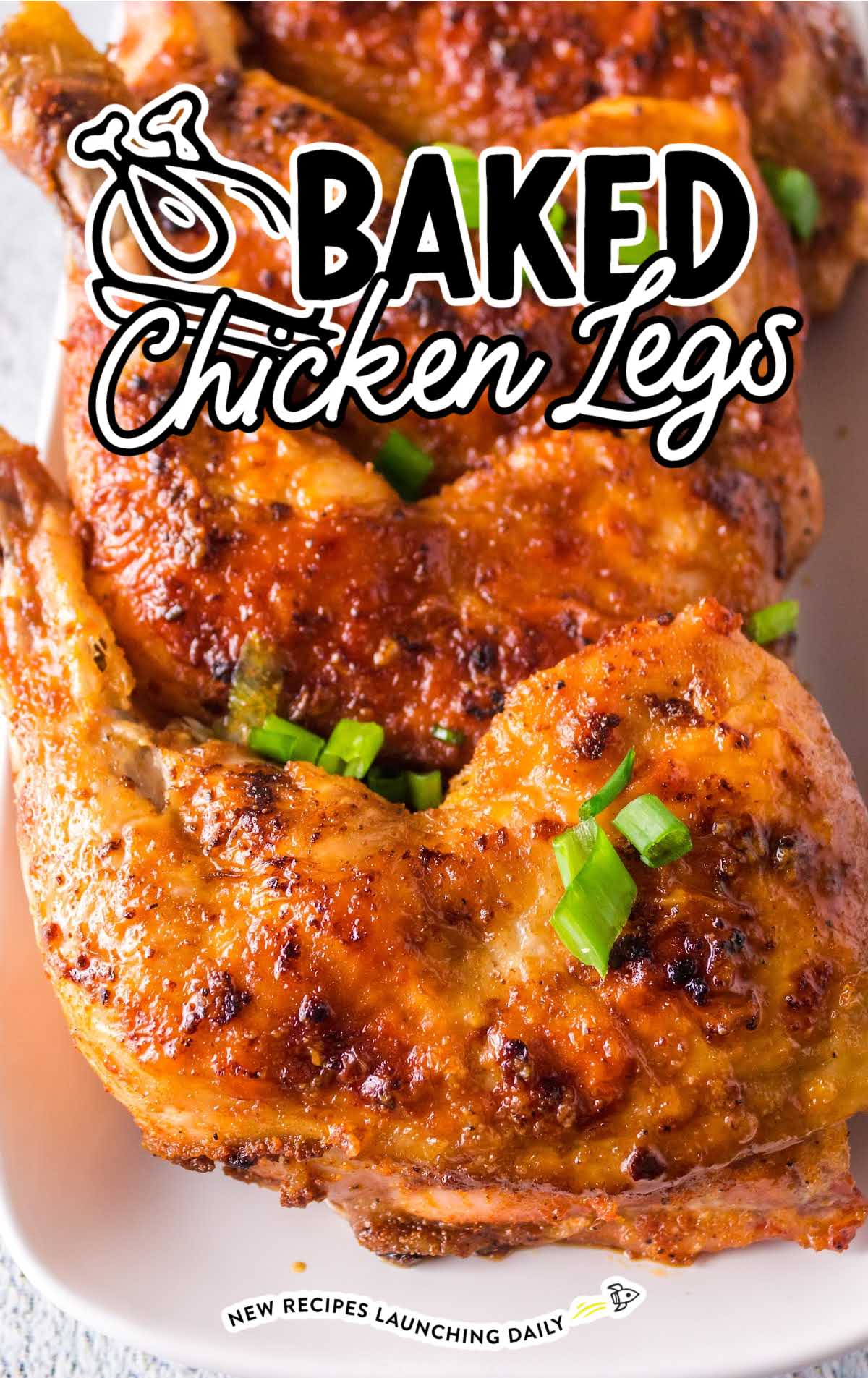 close up shot of Baked Chicken Legs garnished with green onions on a plate
