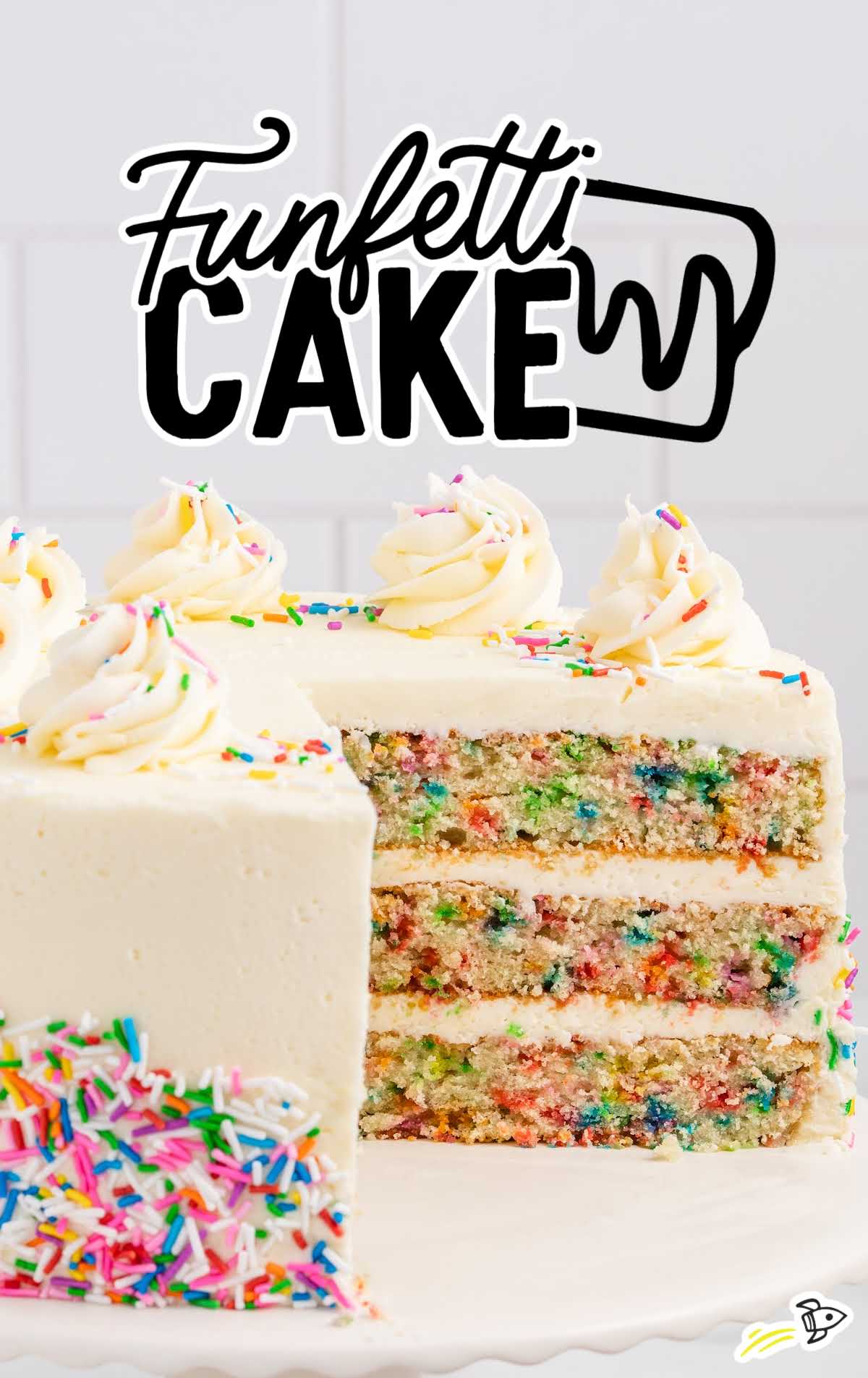Funfetti Cake on a cake stand with a slice taken out of it
