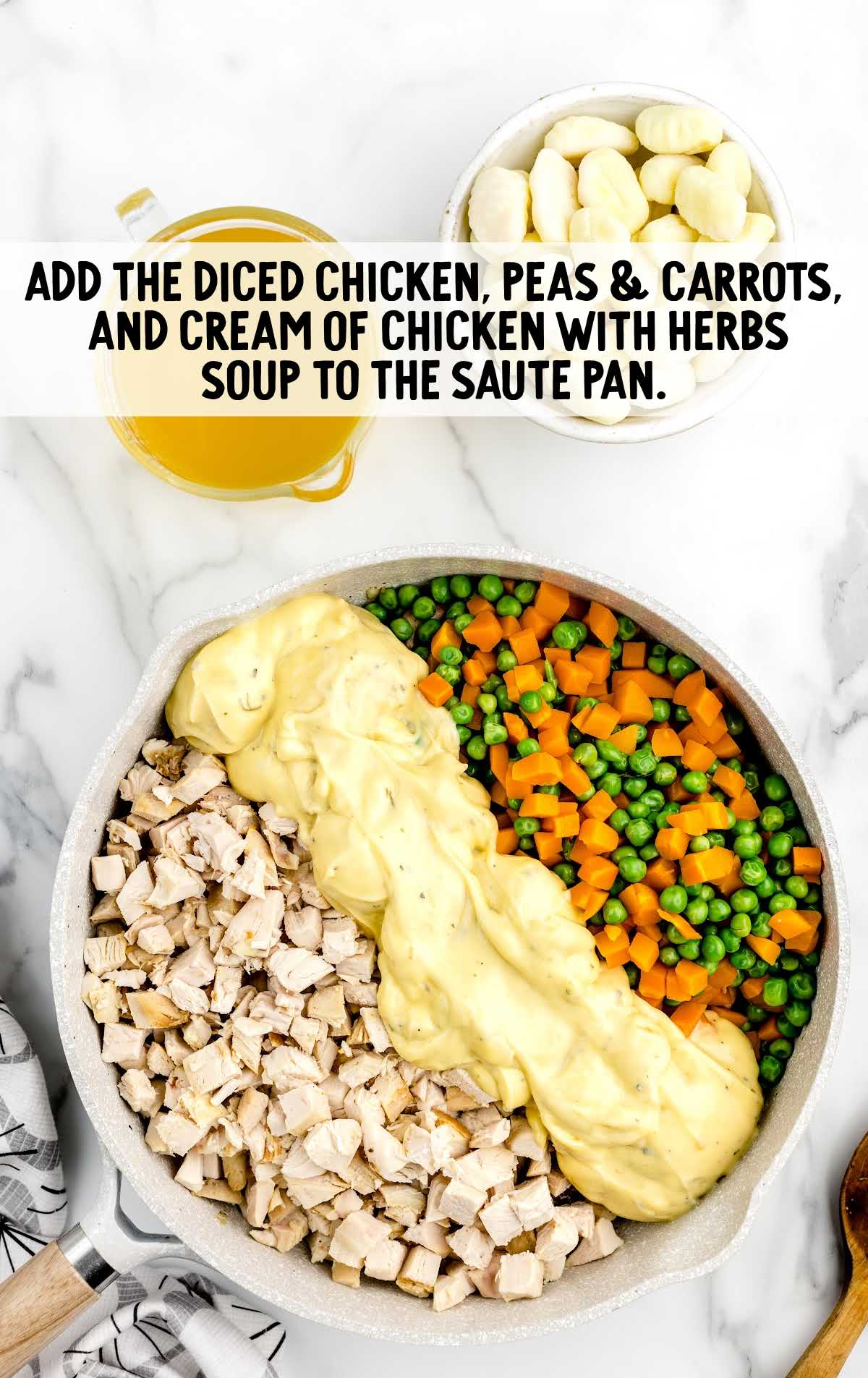 diced chicken, peas, and carrots, and cream of chicken with herbs soup added to the saute pan