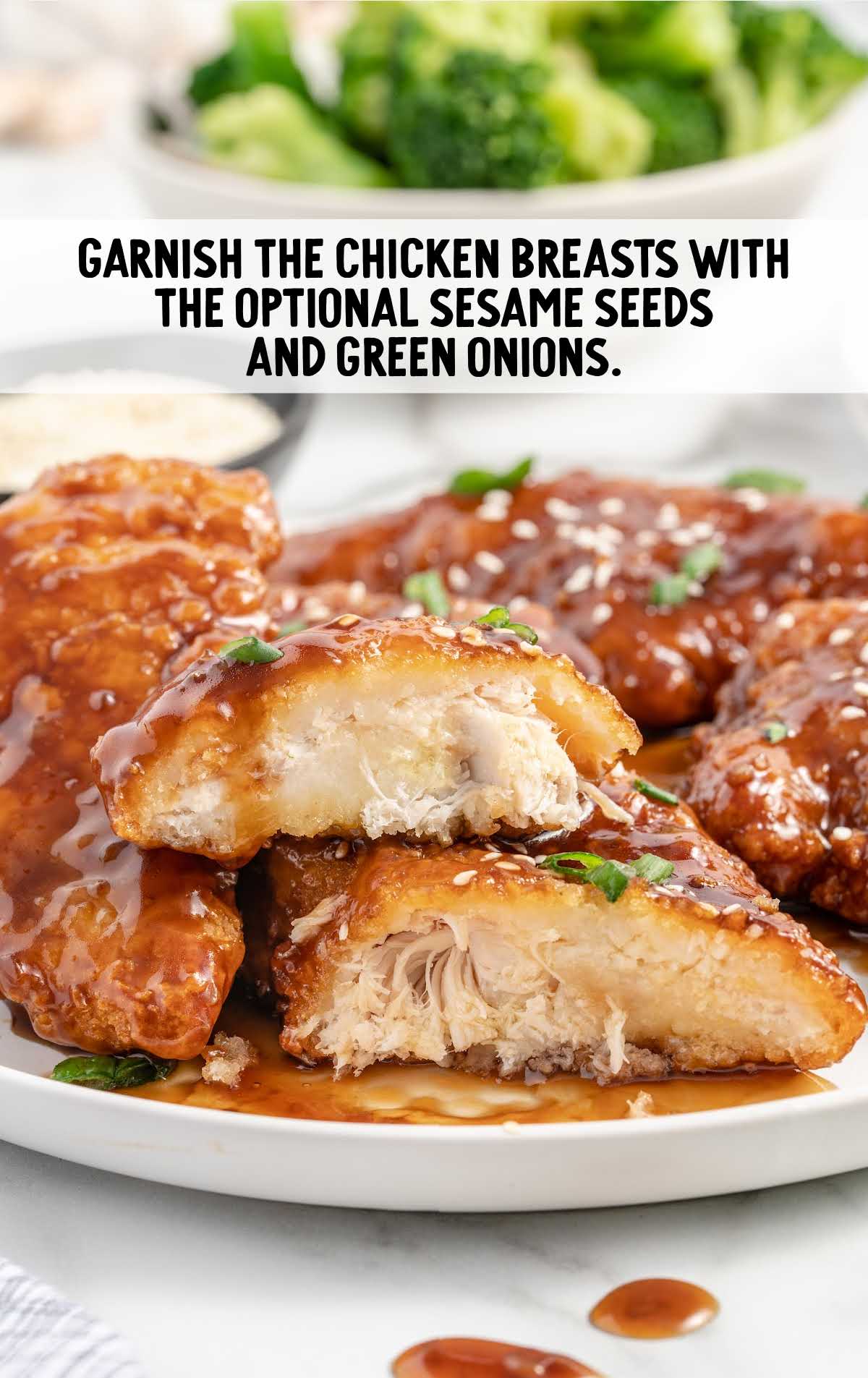 honey garlic chicken breasts garnished with sesame seeds and thinly sliced green onions