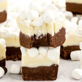 close up shot of Hot Chocolate Fudge stacked on top of each other with one having a bite taken out of it
