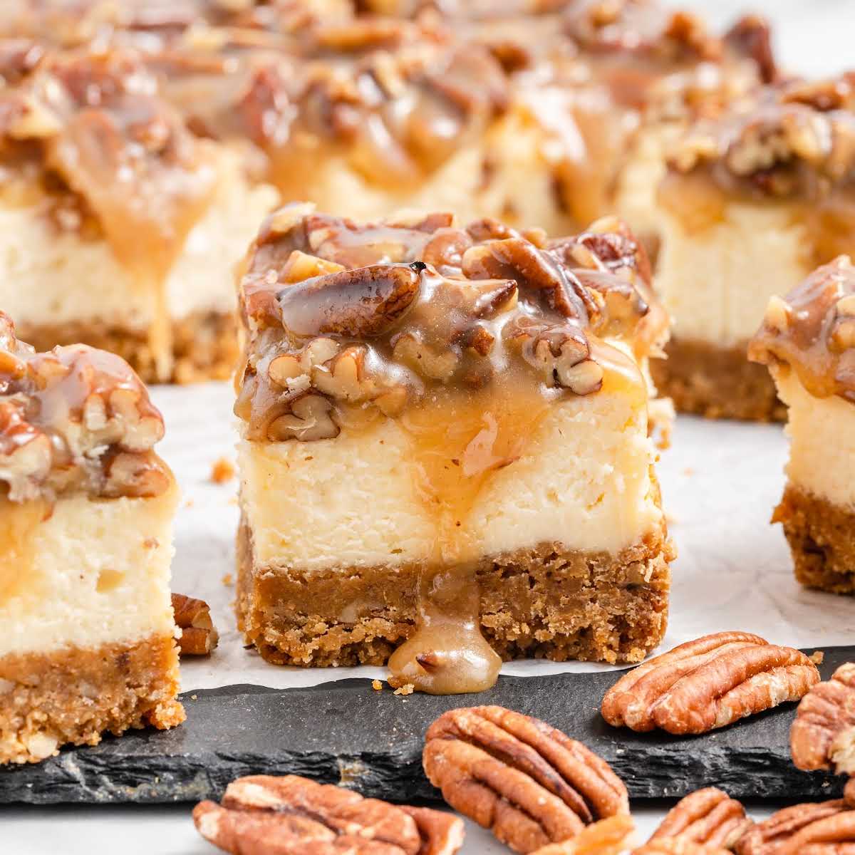 a close up shot of a slice of Pecan Pie Cheesecake Bar