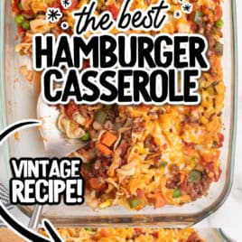 A glass baking dish filled with cheesy Hamburger Casserole, topped with melted cheese, peas, carrots, and noodles. Text reads “The Best Hamburger Casserole Recipe” and “Vintage Recipe!” with an arrow pointing to a wooden spoon serving a portion.