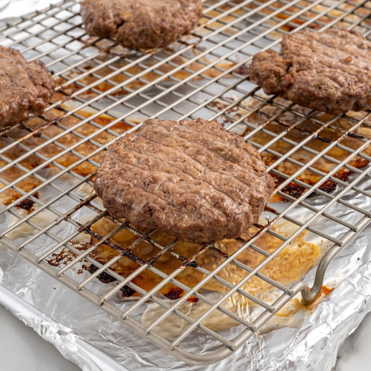 close up shot of Hamburgers on a baking rack