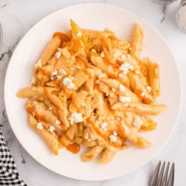 overhead shot of a plate of Buffalo Chicken Pasta topped with blue cheese