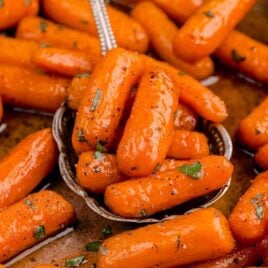a close up shot of Candied Carrots on a spoon