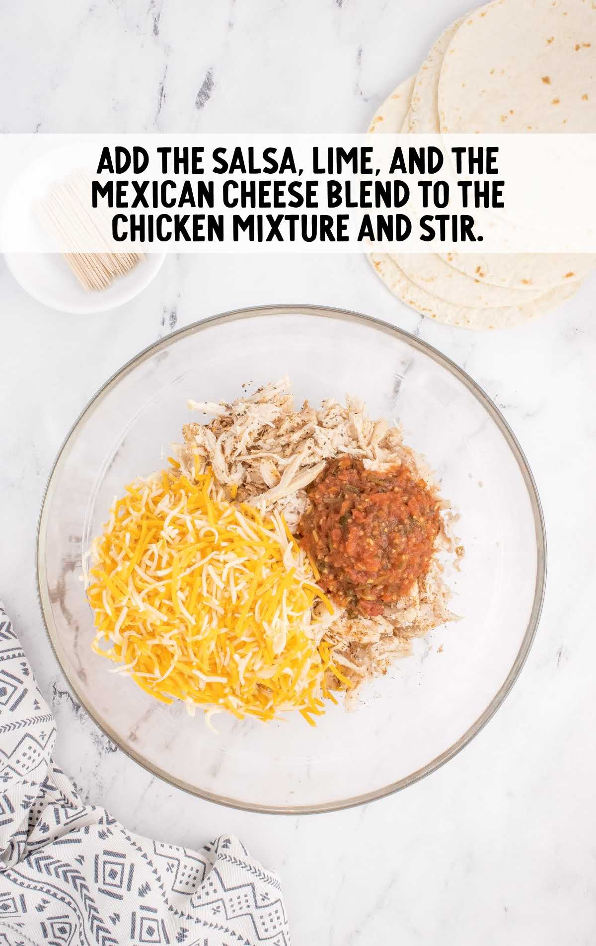 salsa, lime juice, and the Mexican cheese blended into the chicken mixture in a bowl