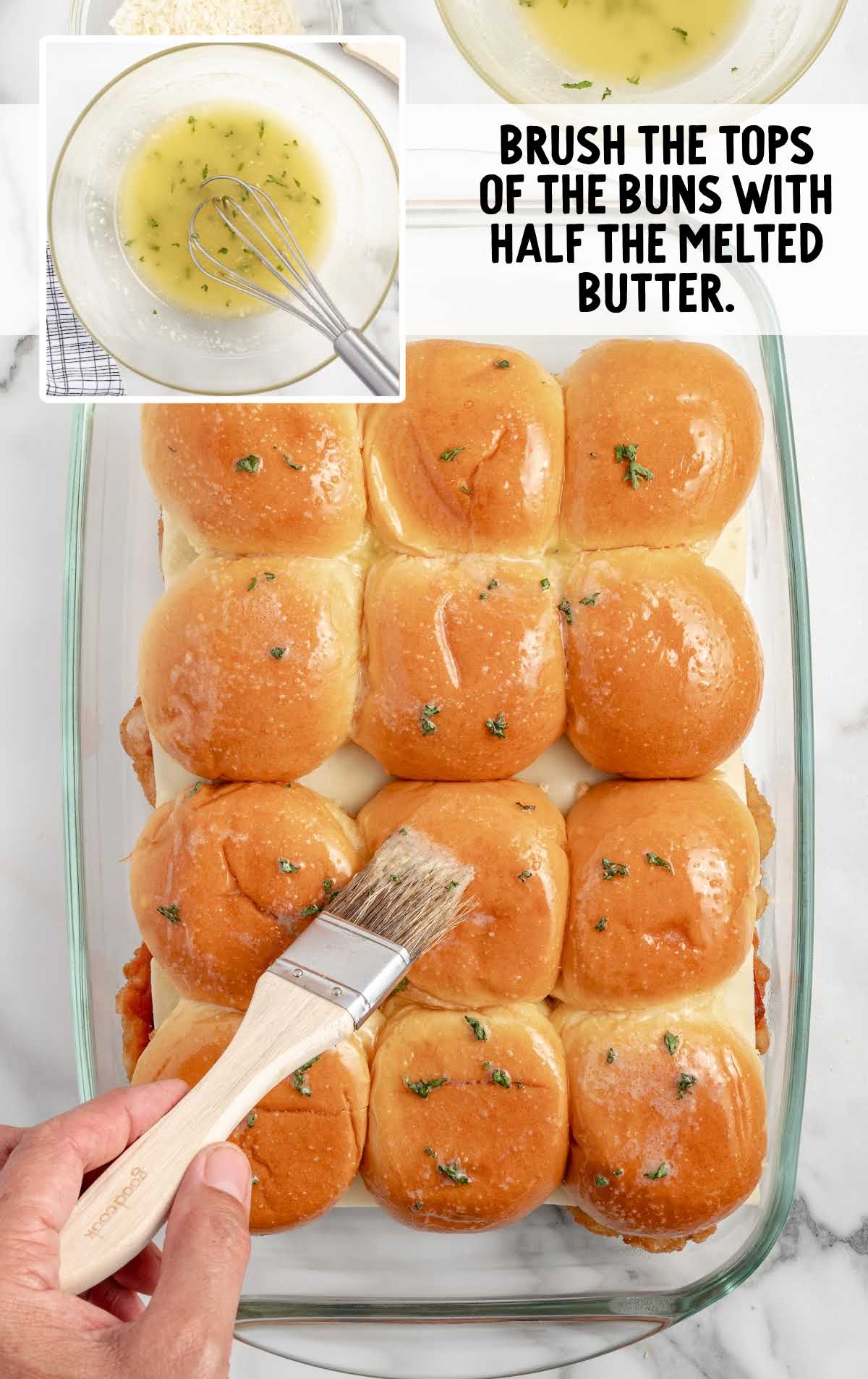 buns brushed with melted butter mixture in a baking dish