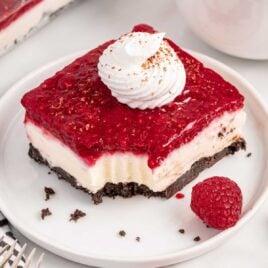 a close up shot of a slice of Chocolate Raspberry Cheesecake Delight with a bite taken out of it