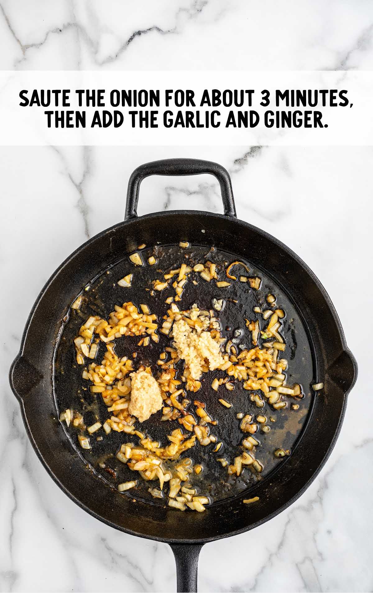 onion, ginger, and garlic combined in a skillet
