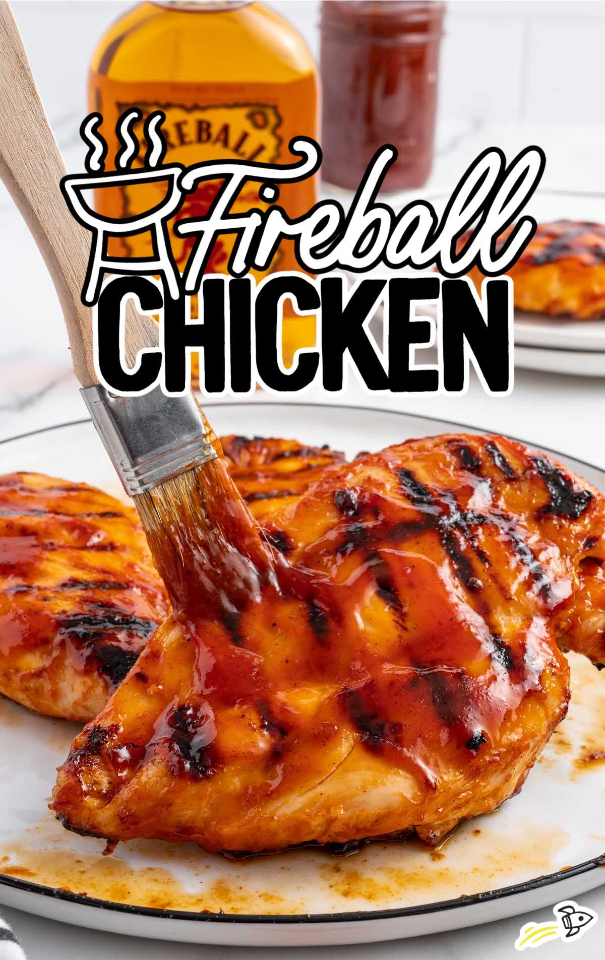 overhead shot of Fireball Chicken being brushed with sauce on a plate