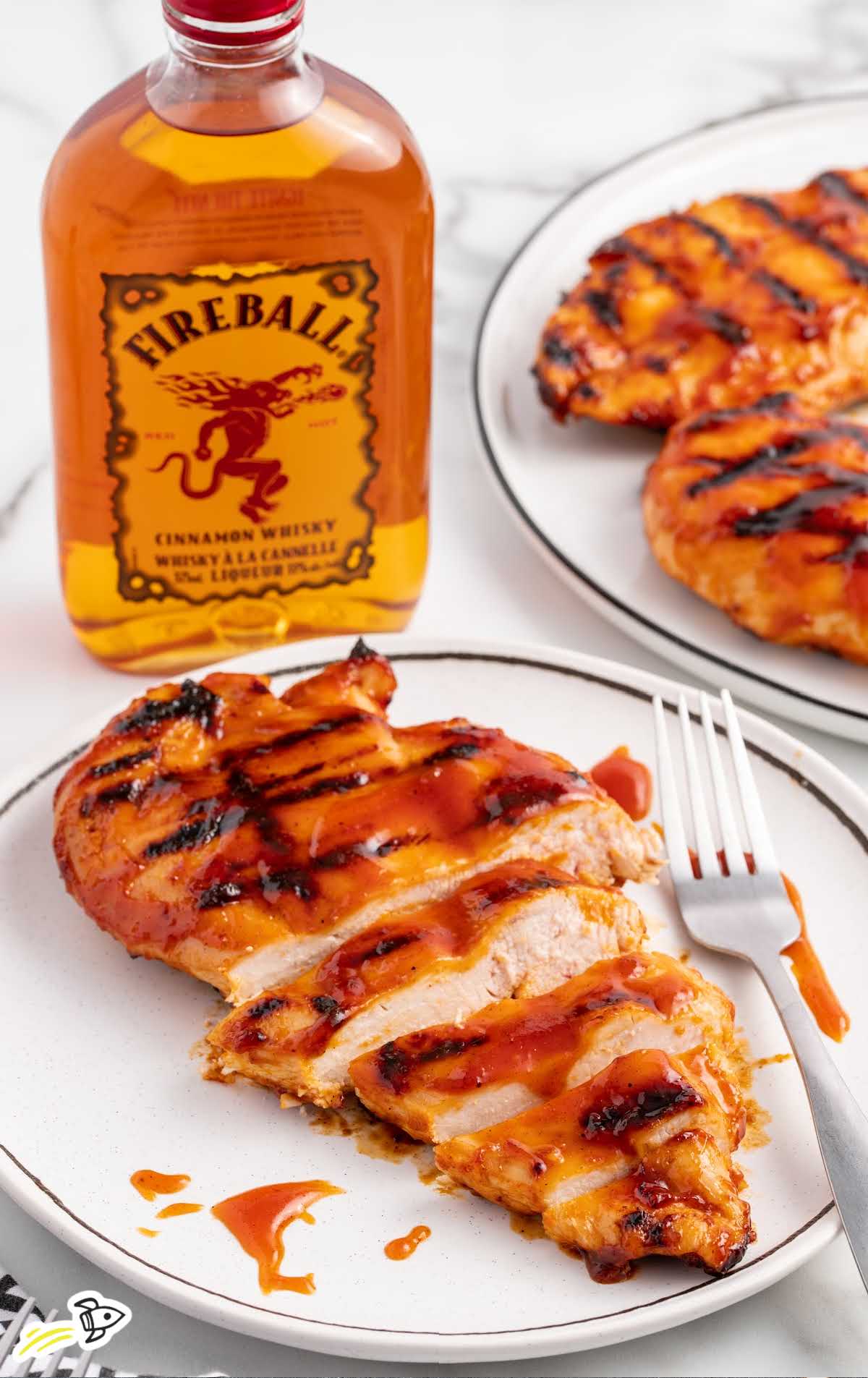 close up shot of Fireball Chicken on a plate sliced into pieces
