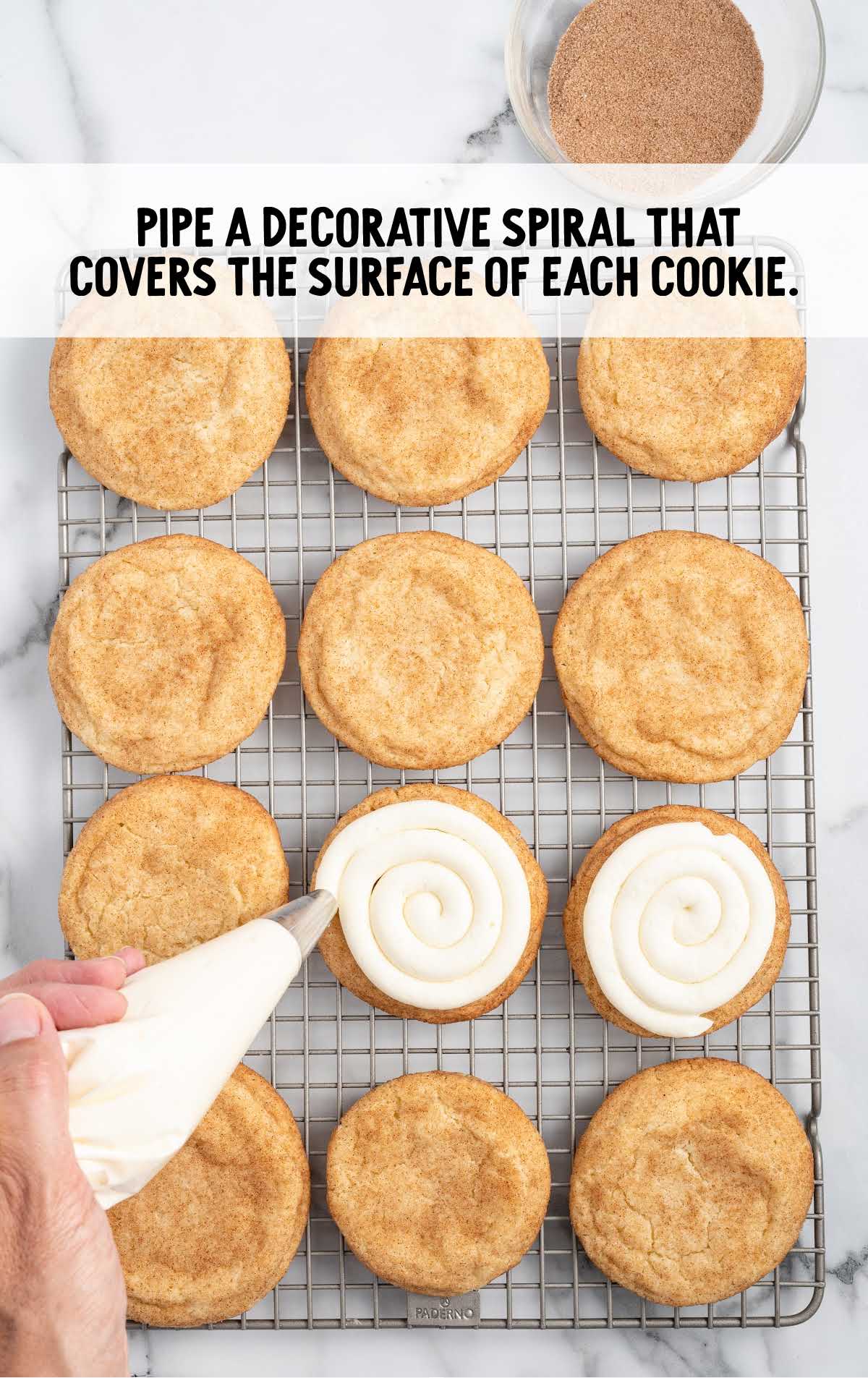 cookies topped with cream cheese frosting on a cooling rack