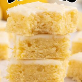 close up shot o fLemon Blondies stacked on top of each other with one having a bite taken out of it