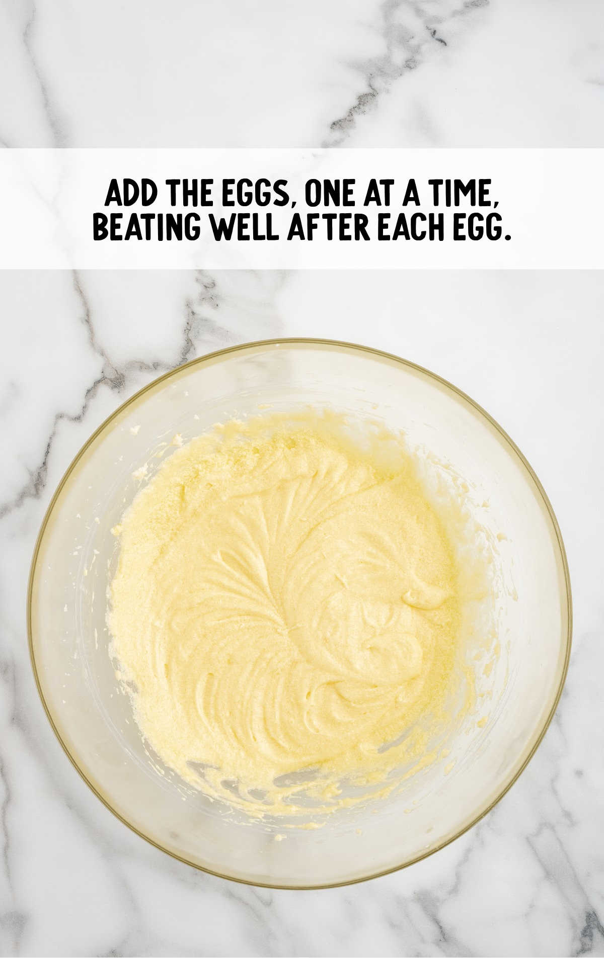 eggs added to the sugar mixture in a bowl
