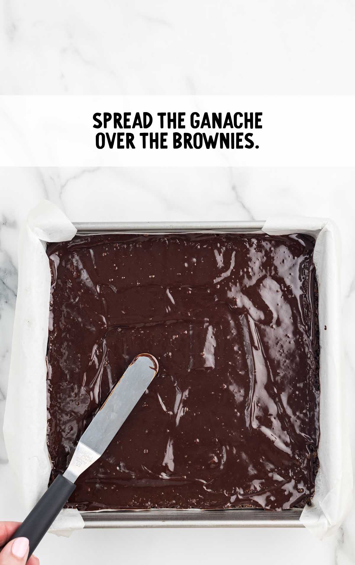 ganache spread over brownie