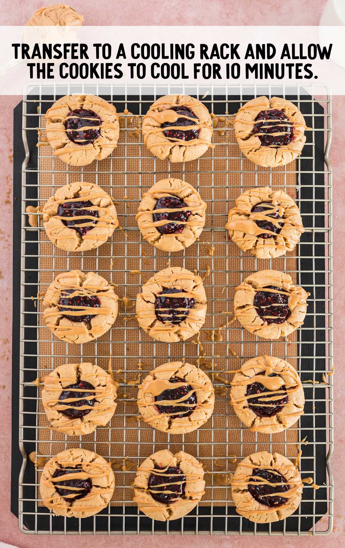 cookies drizzled with melted peanut butter on a cooling rack